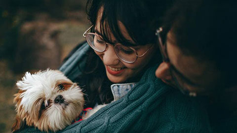 man woman and their dog cuddled up